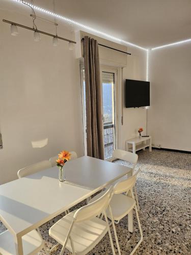 a white dining room with a white table and chairs at Bella Vista da Mario, Lake Como, Front Lake Blevio in Blevio
