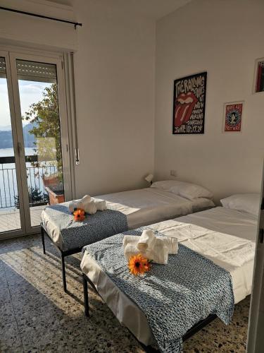 a bedroom with two beds and a balcony at Bella Vista da Mario, Lake Como, Front Lake Blevio in Blevio