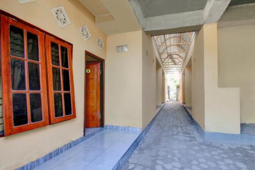 a corridor of a building with doors and windows at OYO Life 92846 Kost Putra Griya Eka in Tanjungkarang