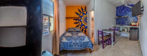 a small room with a bed in a room at Residencia Acosta #2 in Puerto Vallarta