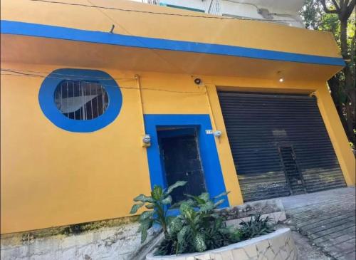 a house with a yellow and blue facade at Residencia Acosta #2 in Puerto Vallarta