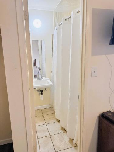 a bathroom with a sink and a mirror at Best Budget Inn in Marshalltown