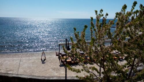 a woman walking on the beach near the ocean at Apartment Nika in Umag