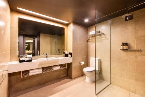 a bathroom with a sink and a toilet and a shower at PARKROYAL Darling Harbour, Sydney in Sydney