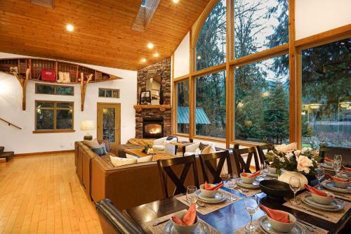 a large living room with a couch and a table at Waterfront Chalet in Maple Falls