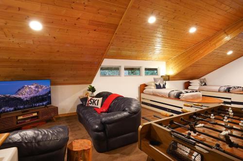 a living room with a couch and a tv at Waterfront Chalet in Maple Falls
