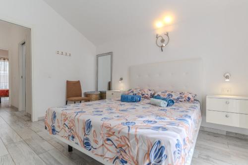 a bedroom with a large bed with blue pillows at Renovated Villa in Las Americas Sea Coast in Playa de las Americas