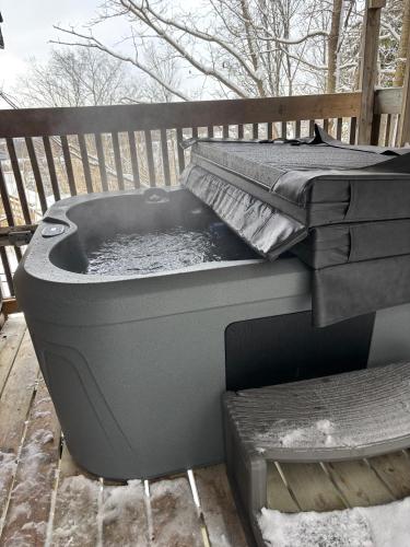 a hot tub sitting on top of a deck at Irish Mountain Suites in Meaford