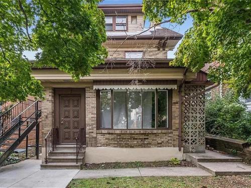a brick house with a door and a staircase at Little France Unit 2 in Allentown