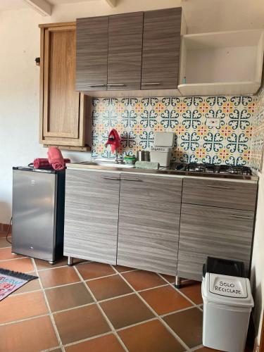 a kitchen with a stainless steel refrigerator and cabinets at Sistarasta in Palomino
