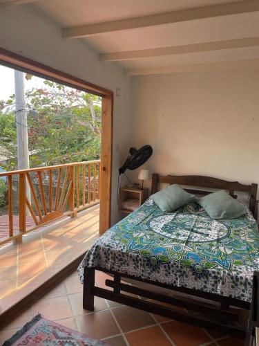 a bedroom with a bed and a balcony at Sistarasta in Palomino