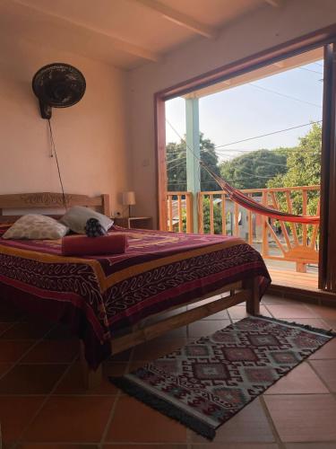 a bedroom with a bed and a large window at Sistarasta in Palomino