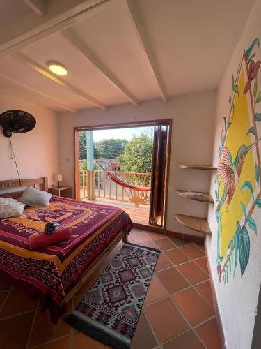 a bedroom with a bed and a large window at Sistarasta in Palomino