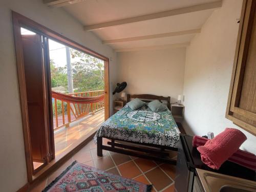 a bedroom with a bed and a balcony at Sistarasta in Palomino