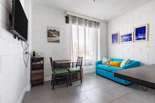 a living room with a blue couch and a table at Prime Location - Newly renovated Quaint 1BR Apt! in Melbourne