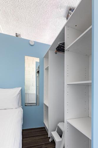 a bedroom with white shelves and a bed at Prime Location - Newly renovated Quaint 1BR Apt! in Melbourne