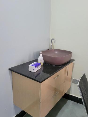 a bathroom sink with a bowl on top of a counter at Biira Transit Residence Entebbe with free airport pickup in Entebbe
