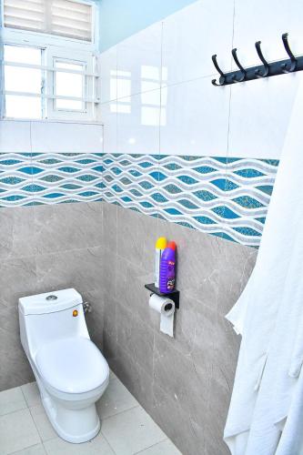 a bathroom with a white toilet in a room at Biira Transit Residence Entebbe with free airport pickup in Entebbe