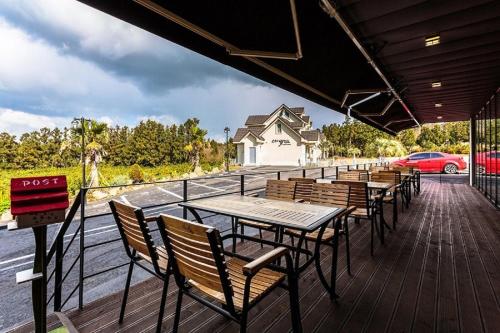 a row of tables and chairs on a deck at Spabellis in Jeju