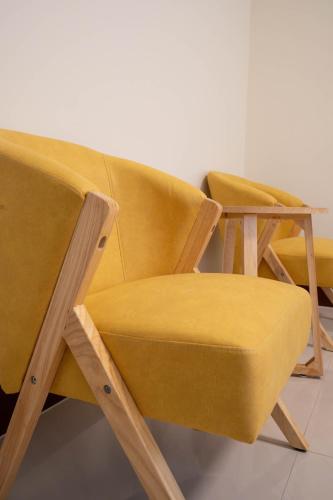 two yellow chairs sitting next to each other at 夏米旅宿 in Lugang