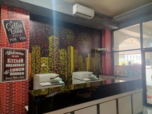 a restaurant with a mural of buildings on the wall at OYO 93090 Multi Plus Inn in Jayapura