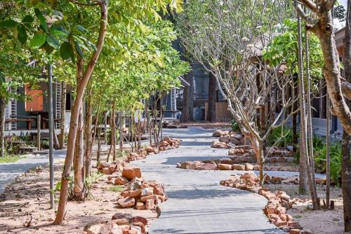 a street with a bunch of animals laying on the ground at Villa Cha Cha Chaolao Beach Resort in Chao Lao Beach