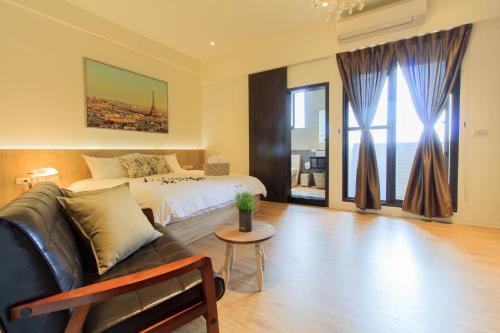 a bedroom with a bed and a couch and a table at Book 5 in Dongshan