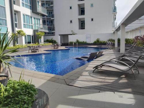 a swimming pool in the middle of a building at Cozy, spacious and well lighted condo in Iloilo City