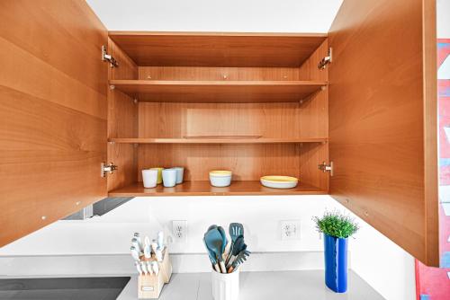 a kitchen with wooden cabinets and utensils at Exclusive unit in Miami Sunshine in Miami