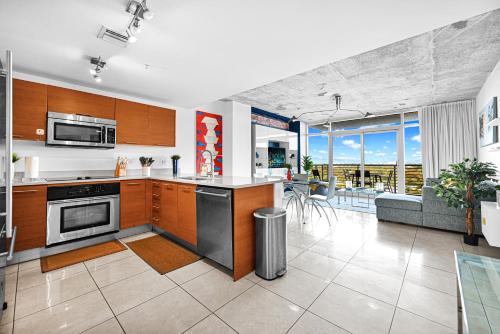 a kitchen and living room with a couch and a table at Exclusive unit in Miami Sunshine in Miami