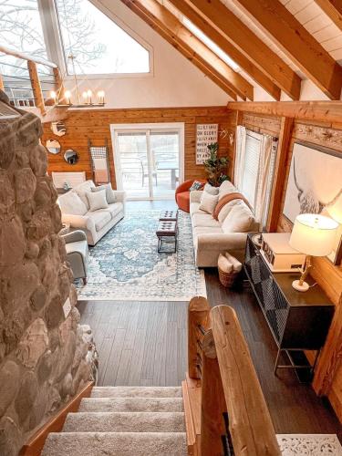 a living room with a stone wall at Cabin Sweet Cabin in Burlington
