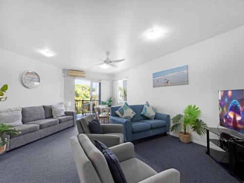 a living room with couches and a flat screen tv at 2-Bed Escape with Pool, Steps From Torquay Beach in Torquay