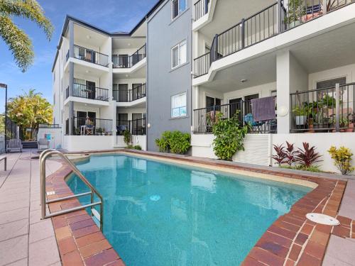 a swimming pool in front of a apartment building at 2-Bed with Pool, Near Torquay Beach, Hervey Bay in Torquay