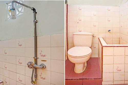 a bathroom with a toilet and a shower at Hotel O Triarga in Takengon