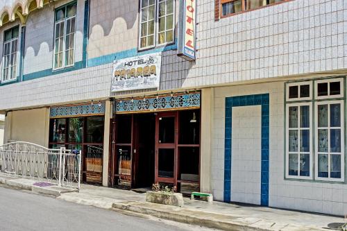 a building on the side of a street with doors at Hotel O Triarga in Takengon