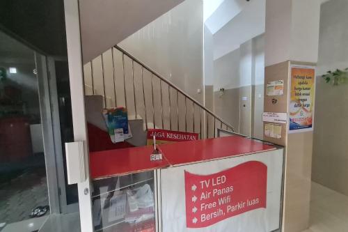 a building with a staircase with a red counter top at Capital O 93250 Hotel Tirta Kencana 2 Baturaden in Banyumas