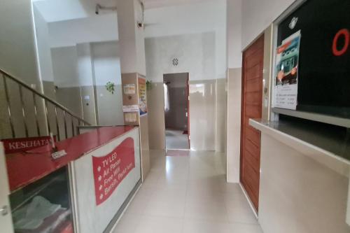 a hallway of a building with a staircase and a lobby at Capital O 93250 Hotel Tirta Kencana 2 Baturaden in Banyumas