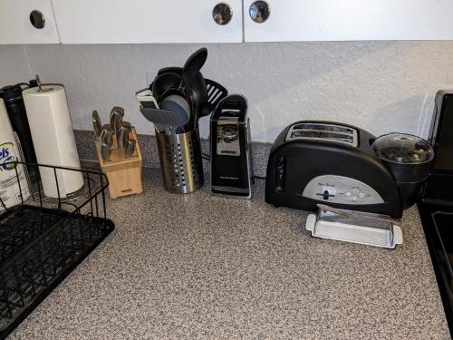 a kitchen counter with a toaster and other kitchen utensils at Introverts Paradise! Central Largo and Pinellas! 15 mins to beaches! in Largo