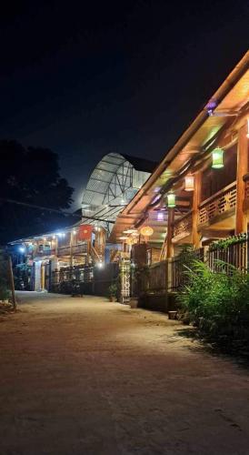 a building with a glass dome at night at House By The Stream in Lũng Tiềm