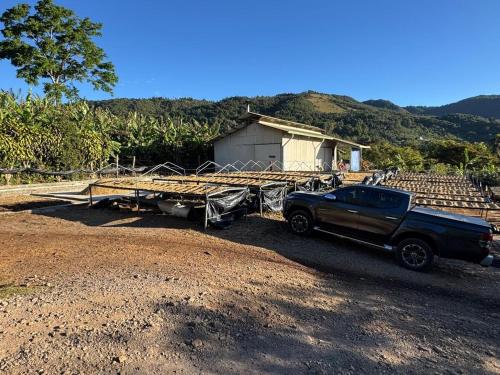 a truck parked in front of a trailer at La Cabaña de Tuto Estate Coffees in San Pablo
