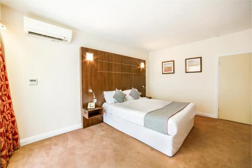 a bedroom with a large white bed in a room at The Bridge House Hotel in Reigate