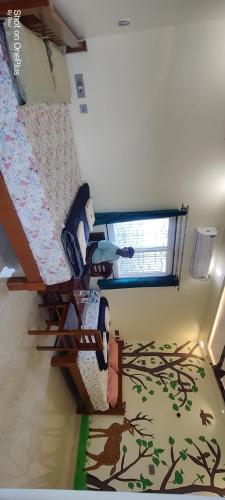 a room with two bunk beds and a window at Archana palace hampi in Hampi