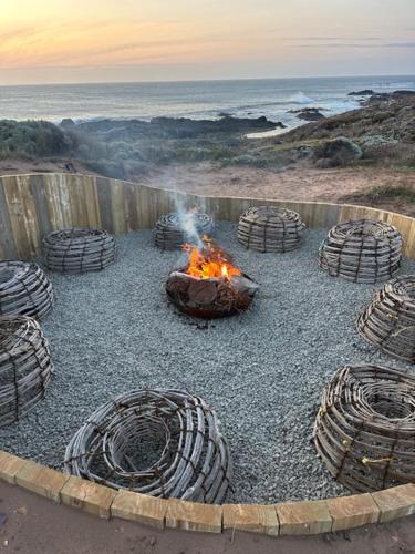 a fire pit with a bunch of tires around it at King Island Lodge - North & South Lodge in Currie
