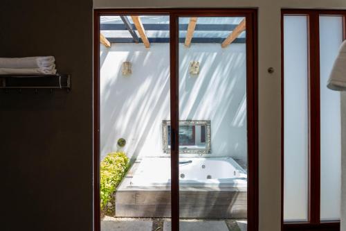 a view of a bath tub through a glass door at Río Tinto Hotel Boutique in Atlixco