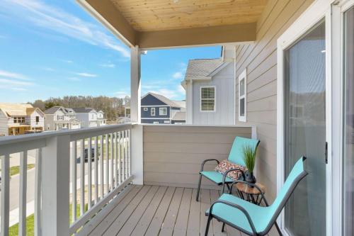 a balcony with two chairs and a window at The Modern Mainstay at Barefoot Bay in Winchester