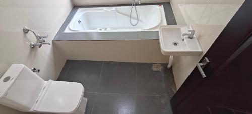 a small bathroom with a sink and a toilet at Rv Resorts Yercaud in Yercaud