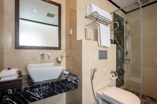 a bathroom with a sink and a toilet and a shower at Silk Path Hotel Hanoi in Hanoi