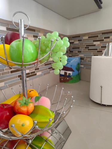 a bowl of fruits and vegetables on a kitchen counter at Hotel Boutique CasAguacate close to Airport, Pedregal, Centro de Convenciones de Costa Rica in Potrerillos