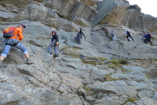 a group of people climbing up a rocky mountain at Haus Bergheim in Sankt Leonhard im Pitztal