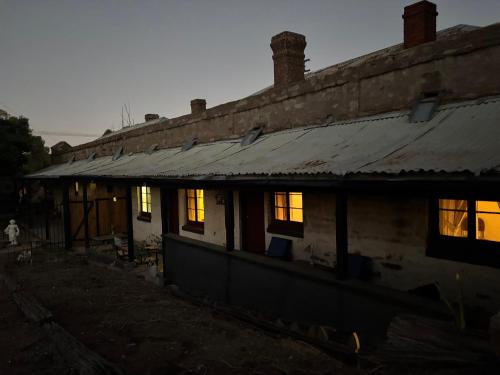 an old house with the lights on at The Smelters Home Burra in Burra